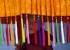 Image: A young monk holds a traditional parasol as he waits for the arrival of Tibet